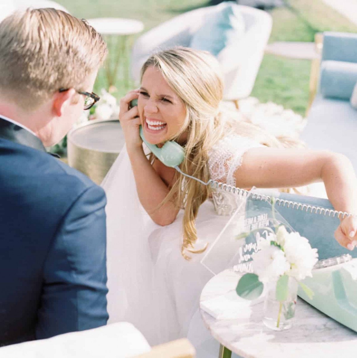 bride giggling while listening to audio guest book for weddings messages